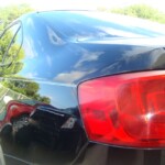 Before and after photographs of a damaged black Volkswagon Jetta that was repaired by Elite Paint & Body Shop in West Palm Beach, Florida.